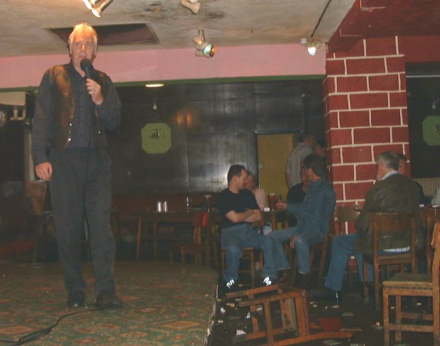 Comedian Stu Barker performing on the stage of the variety club Radfors Notts